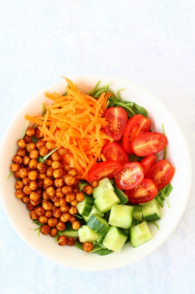 healthy roasted chickpea salad bowl with chickpeas, cucumber, carrot and tomatoes