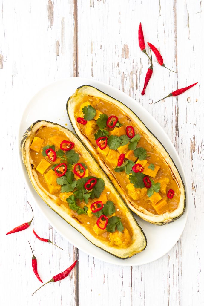 stuffed baked marrow with chicken curry topped with chillies and coriander