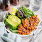 Spicy sweet potato fritters with salad and avocado